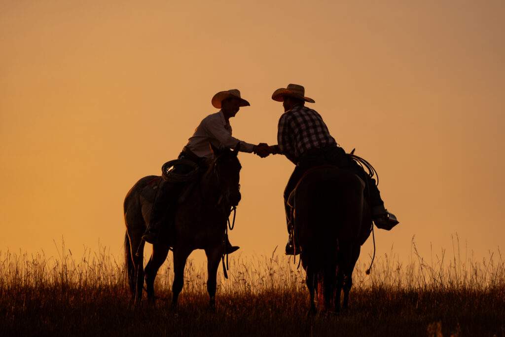 9797871960340-Ranchers Shaking Hands on Horseback 163000