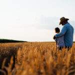Farmer,And,His,Son,Walking,Fields,Of,Wheat